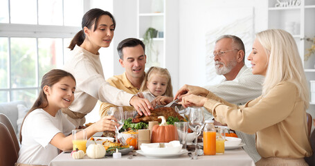 Sticker - Happy family having dinner at festive table on Thanksgiving Day