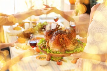 Sticker - Young woman with turkey during festive dinner on Thanksgiving Day