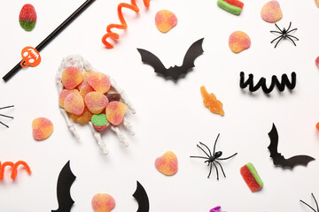 Poster - Composition with sweet jelly candies and Halloween decorations on light background