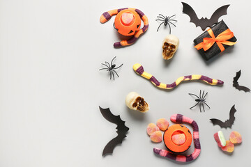 Poster - Composition with Halloween decorations and sweet jelly candies on grey background