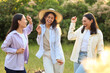 © Pixel-Shot - Female friends dancing on picnic in park