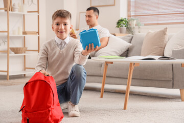 Poster - Little boy with school lunchbox and backpack at home