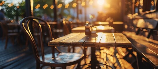 Wall Mural - outside restaurant chair table on a dark wood floor outdoors with glare light blur background