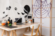 © Pixel-Shot - Interior of office decorated for Halloween with workplace and folding screen