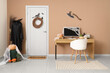 © Pixel-Shot - Interior of office decorated for Halloween with door, witch costume and workplace