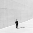 © Sumet - A solitary figure in a suit walking towards a minimalist wall, embodying themes of solitude and introspection in a modern setting.