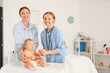 © Pixel-Shot - Mother and nurse with stethoscope listening to newborn baby on table in maternity hospital