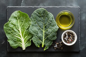 Canvas Print - Fresh collard greens with olive oil and pepper on slate