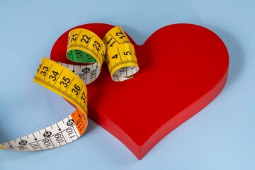 red heart shape with measuring tape symbolizing health care