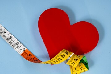 red heart shape with measuring tape symbolizing health care