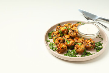 Stuffed mushrooms, sauce and cutlery on white background, space for text