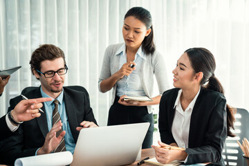 Wall Mural - Diverse of business people from various ethnic group working in modern office environment. Productive and multi ethnic office workers engage in discussion for strategic business marketing. Habiliment