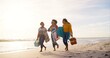 © Nina2024/peopleimages.com - Happy, picnic and girl friends on beach for weekend trip, vacation or travel with bonding together. Walking, adventure and group of young women laughing by ocean for seaside tropical holiday.