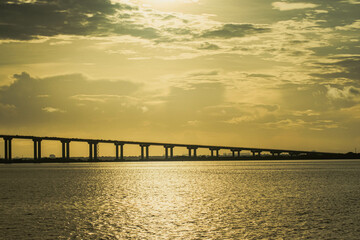 The Mactan Channel in Cebu, Philippines is a busy waterway that connects the Mactan Island and the mainland. It is home to numerous buildings, cargo ships, bridges, serving as a vital hub for trade