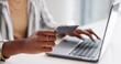 © Nina2024/peopleimages.com - Black woman, hands or laptop with credit card for online banking, shopping or payment on desk. Closeup, young African or female person with debit or computer for ecommerce order or remote transaction