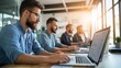 © CHOI POO - Focused Coders in the Zone: A team of male software developers concentrate intently on their laptops in a modern, sunlit office, embodying the dedication and collaboration of the tech industry.
