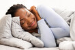 © Prostock-studio - Healthy Sleep. Asleep African American Lady Hugging Herself Resting Lying In Bed At Home. Selective Focus