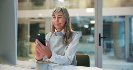 Poster - Mature woman, office and checking phone for online chat, business communication or contact at night. Overtime, smartphone and senior businesswoman reading email, review or message at digital agency