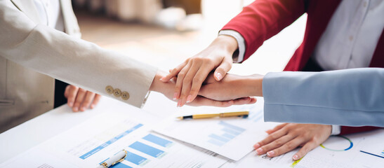 Wall Mural - Three people shake hands in a business meeting