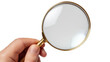 © Nhan - Hand holding magnifying glass
