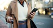 © Nina2024/peopleimages.com - Woman, phone and hands with luggage in street to travel with taxi app, transport and commute in city. Professional, person and smartphone for cab location, trip details and ride service on sidewalk
