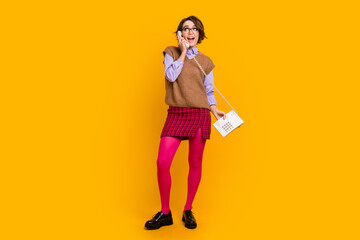 Wall Mural - Photo portrait of attractive young woman look empty space phone call dressed retro office clothes isolated on yellow color background