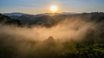 Sunrise view with mountains and forests with morning fog