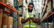 © peopleimages.com - Phone, worker and black man in warehouse for shipping, distribution or stock inspection on app. Mobile, factory or happy logistics engineer check inventory for export, supply chain or quality control