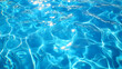© Neural9 Project - Close-Up View of the Surface of a Clear Blue Pool Water with Ripples and Glimmering Sunlight Reflections