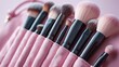 © visoot - Makeup brush set in a pink bag on a pastel background. Generative AI.