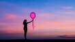 © Soemsuk - A silhouette holds a pink balloon against a vibrant sunset sky, capturing a moment of tranquility and whimsy