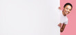 © Prostock-studio - Great Offer. African American Girl Peeking Out Of Blank White Poster Standing Over Pink Studio Background. Panorama, Mockup