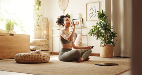 woman, drinking water and yoga in home for fitness, peace or thirsty in session on floor. girl, bott