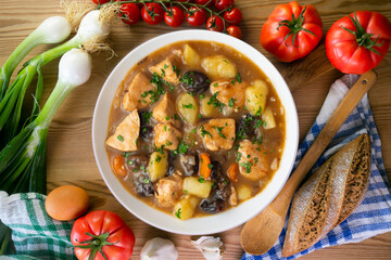 Turkey stew with prunes and potatoes. Top view table with  decoration.