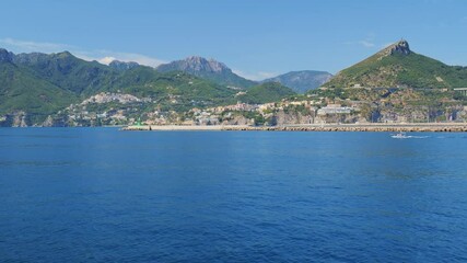 Wall Mural - Salerno, Italy. Seascape of ​​the Amalfi Coast, from the port of Salerno to Vietri sul Mare, Raito and Albori. Taken from a moving boat sailing along the Amalfi Coast. Real time 4K video.