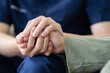 © itchaznong - Empathy, trust and nurse caregiver holding hands with patient. consulting support and healthcare advice