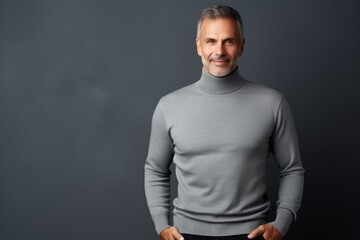 Poster - Portrait of a tender man in his 40s wearing a classic turtleneck sweater on soft gray background