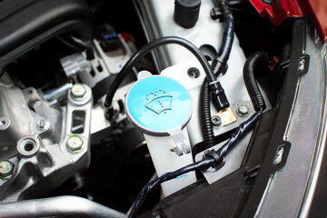 Close up of a blue cap of windscreen wiper fluid reservoir , windshield wiper reservoir , Car spare parts concept