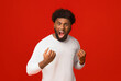 © Prostock-studio - Furious black man shouting over orange background, ready for fight