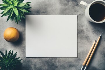 A flat lay of a blank white sheet on a textured surface, surrounded by a cup of coffee, an orange, two pens, and green succulents, creating a balanced and aesthetically pleasing workspace setup