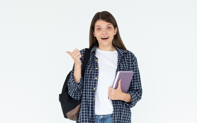 Wall Mural - Hey look. Smiling pretty female model pointing fingers left at empty space and inviting to check it out, showing advertisement on white background. Girl with notepads in hands.