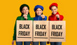 © Prostock-studio - Black Friday Sales. Three Multiethnic Girls Holding Shopping Bags With Promo Text Standing Over Yellow Background. Panorama