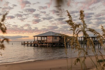 Wall Mural - Serene beach scene at sunset with stilt houses