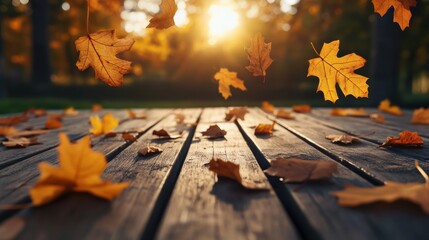 Poster - Autumn leaves gently falling onto a wooden table surface with a warm sunlight glow and soft shadows 