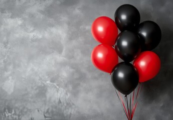 Red and black balloons set against a textured gray background for a festive celebration