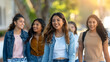 © Mahemud - A group of beautiful young Hispanic women walking together outdoors. Candid photo of young adults having fun