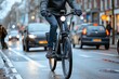 © SY - A man riding an e-bike on a city street. This photo represents the modern trend of using sustainable transportation for daily commutes.