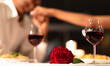 © Prostock-studio - Romantic Date Background. Red Rose Lying On Table, Loving Black Man Kissing Woman's Hand During Dinner In Restaurant. Selective Focus