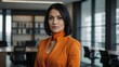 © Alteisen Riese - adult black hair european woman in orange formal attire model portrait looking confident on an office background for ad concept space for text