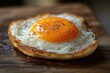© julija - perfectly fried egg on rustic wooden surface vibrant yolk wispy edges food photography style